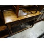 A 20th century oak console side table with two drawers raised on turned supports.