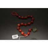 An amber style necklace with Jade crisp in the form of a Buddha