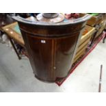 A georgian 19th century mahogany bow fronted corner cupboard with doors open to reveal shelved