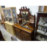 An oak early 20th century mirror backed sideboard with carved floral panel doors and drawers and