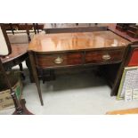 A 19th century mahogany serpentine fronted side table with two raised on tapering square legs.