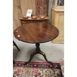 A Georgian mahogany tilt top tripod table raised on pad feet.