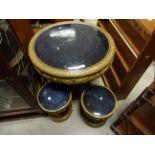 A circular oriental style ceramic stoneware table and stools with dragon decoration.