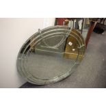 A large circular art deco mirror.