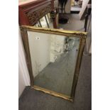 Large bevelled mirror with detailed engraving, all set in an old ornate frame