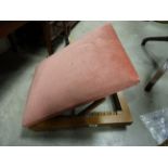 A vintage pink upholstered adjustable gout stool.