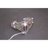 Silver plique a jour bangle in the Art Deco style with central opal panel