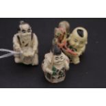 Group of three netsuke style resin carvings of baby with cat, basket maker and a fisherman