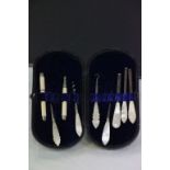 Leather cased Vanity set with carved Mother of Pearl handles to include corkscrew, button hook,