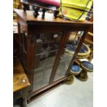 A contemporary oak glazed display cabinet with astragal glazed doors.