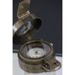 A brass compass stamped TG COLTD London 1940 with crows foot mark.