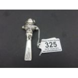 Silver babies rattle in the form of a young lady with Mother of Pearl handle
