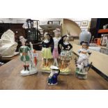 Two Staffordshire figures, a small Toby jug and a Continental figure of a girl with lamb