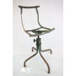 A vintage adjustable metal swivel chair for repair.
