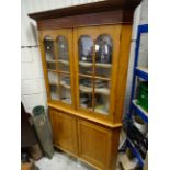 A mahogany glazed topped corner cabinet with two doors below raised on turned supports.