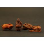 Four wooden miniature netsuke figures to include a Chinese Dragon, Rabbit, Buddha and one other