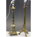 A brass column lamp of classical form raised on claw feet and one other similar.