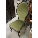 Victorian Mahogany Carved Large Spoon Back Nursing Chair with green stuffed back and seat, carved