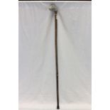 Long walking stick with a horse head handle