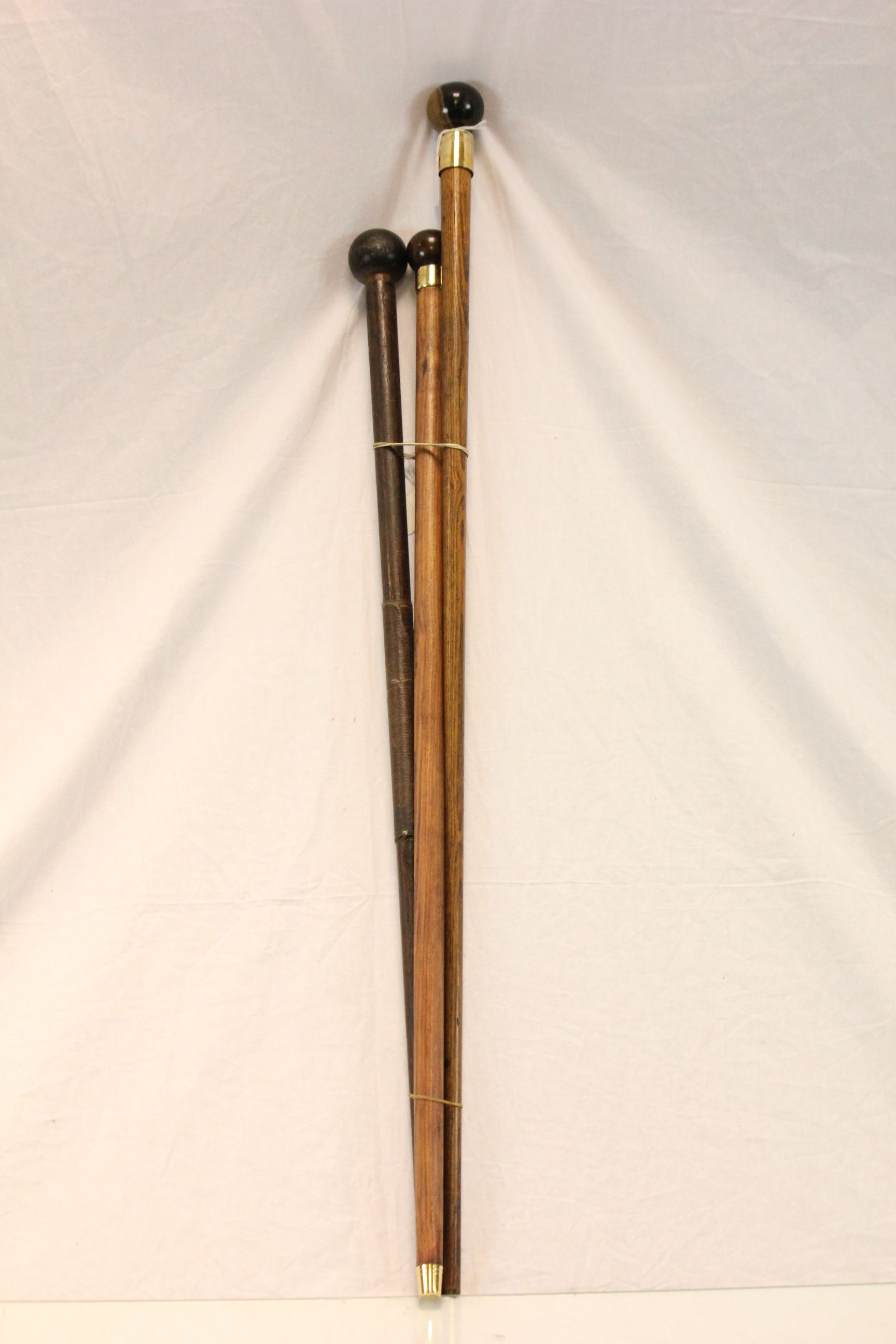 Three Walking Sticks, each with ball handles