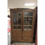 Early 20th century Oak Part Glazed Cabinet, the two doors opening to reveal oak shelves