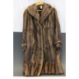 A vintage full length fur coat in a suit carrier