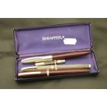Three vintage shaffer fountain pens, one boxed to include gold nibbed