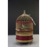 Wooden mechanical singing bird in a cage