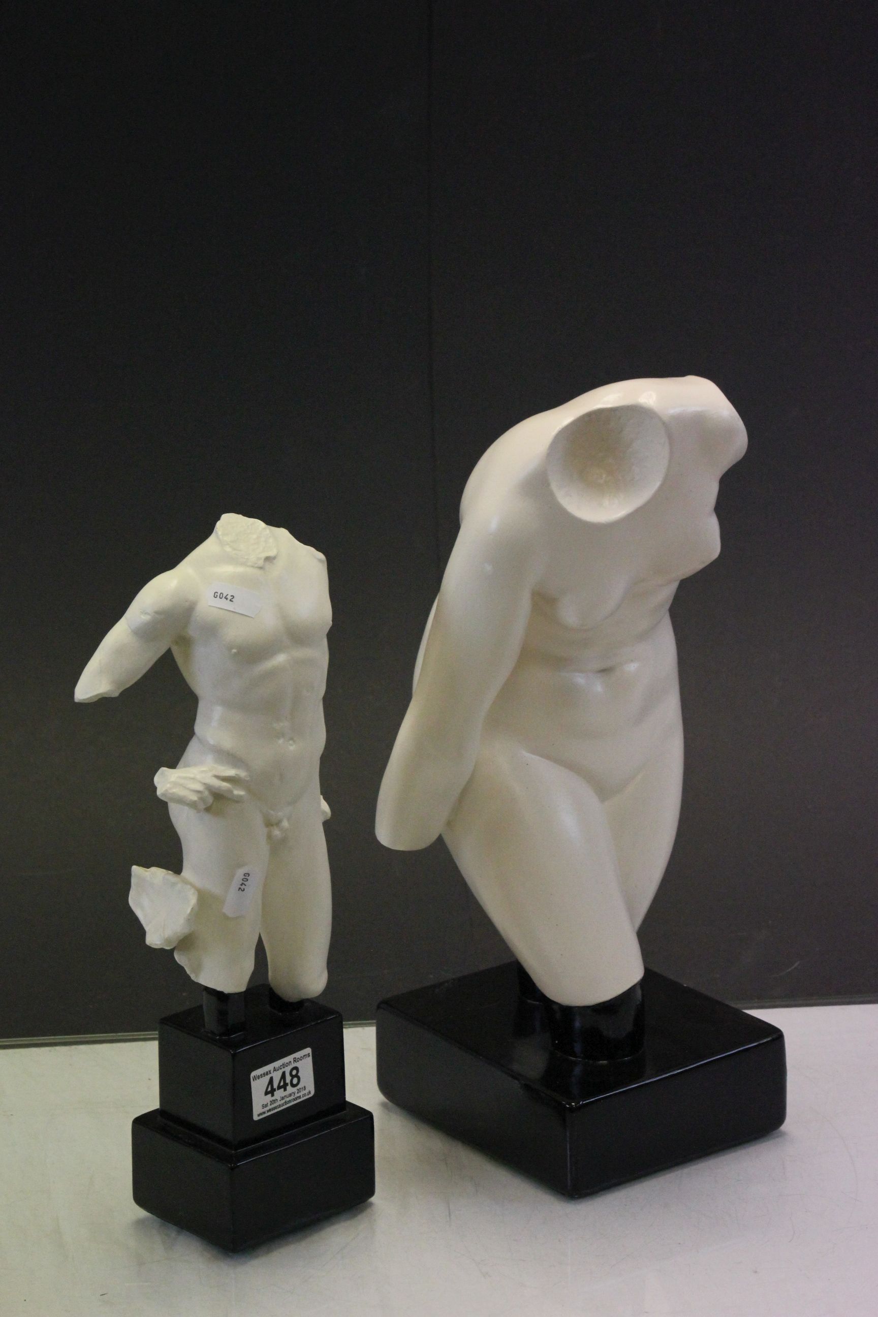 Two human torso sculptures.