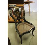 19th century Black Lacquered Nursing Chair decorated with floral sprays and mother of pearl with