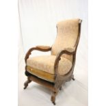 Victorian Mahogany Framed Rocking Chair with carved scroll arms and sides raised on castors