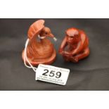 Two wooden netsuke carvings to include a Mandarin Duck and a Monkey