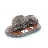 Bronzed effect metal recumbent Lion on a wooden plinth