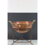 Large beaten Copper pan with two Brass handles on a cast Iron tripod base