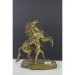 Brass model of a rearing horse with man trying to calm it