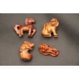 Four Small Chinese Wooden Netsukes in the form of Animals