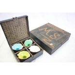 Oriental boxed set of four ceramic leaf bowls with coloured glaze interiors and a wooden record box