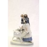 Royal Copenhagen model of a girl holding a mallet with two goats, number 692