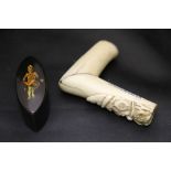 An antique ivory walking stick handle decorated with dog in French military hat