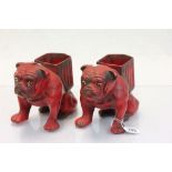 Pair of ceramic planters in the form of seated dogs with glass eyes and with a Red finish