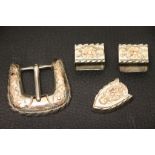 A silver and gold buckle and belt fittings