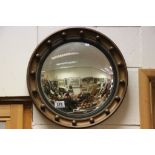 A vintage gilt circular mirror with convex looking glass