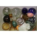 A quantity of glass paper weights and other glassware.