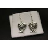 A pair of silver earrings in the form of doves' wings