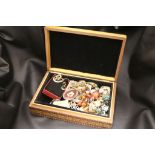 A wooden jewellery box containing costume jewellery including silver