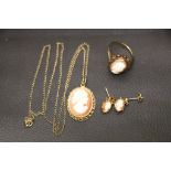 A cameo suite comprising of a 9ct gold ring, size P, 9ct gold earrings, and a 9ct gold pendant