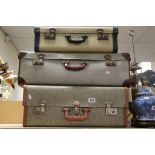 Four vintage suitcases, some with keys