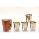 Set of Four Stacking Stirrup Cups, each with different coloured Enamel Band and Gilt Interiors,