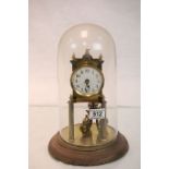 Brass Anniversary clock with enamel dial and glass dome