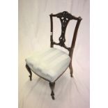 Early 20th century Nursing Chair with ornately carved back rail and splat